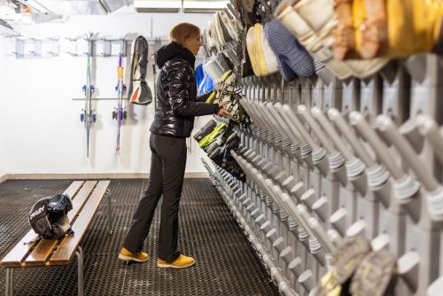 a woman is standing in a hockey room at Hotel Derby in Folgarida