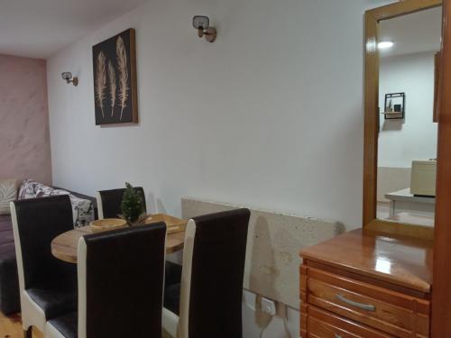 a dining room with a table and chairs and a mirror at Simic Apartmani Tara in Kaludjerske Bare