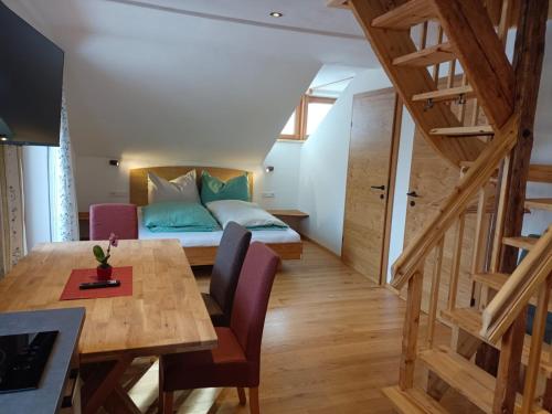 a room with a bed and a table and chairs at Chalet Leni in Schladming