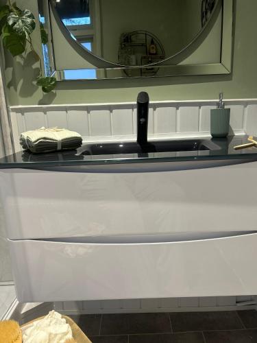 a bathroom counter with a sink and a mirror at Park View is a beautiful whole entire house close to town centre, sleeps 8 in 4 rooms, 2 doubles and 4 single beds with 2 shower rooms, available for holidays, insurance stays, trades people, contractors, pets welcome in Wisbech