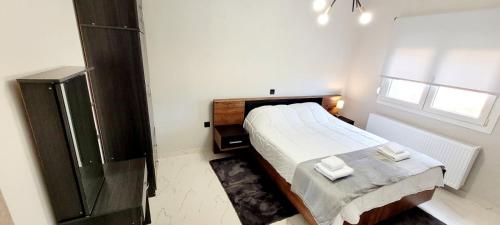 a small bedroom with a bed and a window at Casa Montagna in Florina