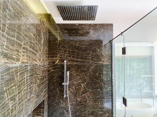 a bathroom with a shower with a glass door at Designer Panoramic Seaview 2br Pool Villa Naithon Beach num7131 in Nai Thon Beach