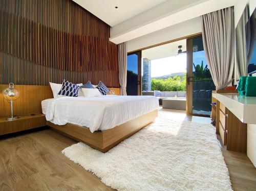 a bedroom with a large bed and a large window at Designer Panoramic Seaview 2br Pool Villa Naithon Beach num7131 in Nai Thon Beach