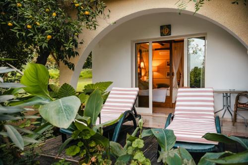 a group of chairs sitting outside of a house at Bellapais Gardens in Kérynia