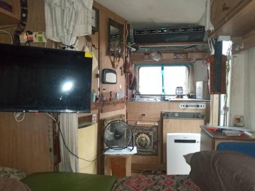 a living room with a tv in a rv at Caravan have TV & Netflix in Bangkok