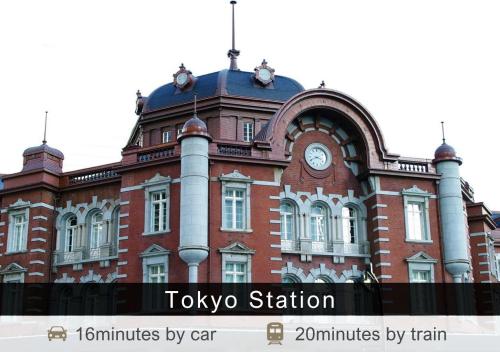 a large brick building with a clock on it at Tokyu Stay Aoyama Premier in Tokyo