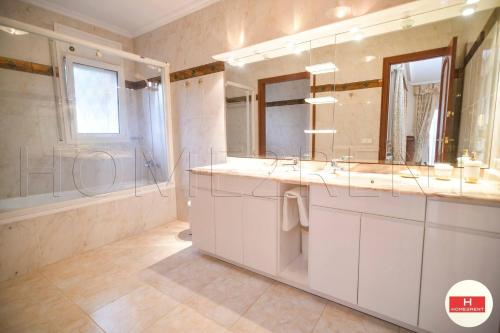 a bathroom with two sinks and a shower at Villa Cerca Del Mar num1125 in Blanes