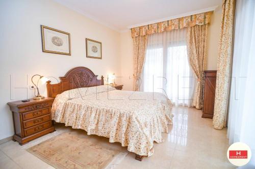 a bedroom with a bed and a dresser and a window at Villa Cerca Del Mar num1125 in Blanes