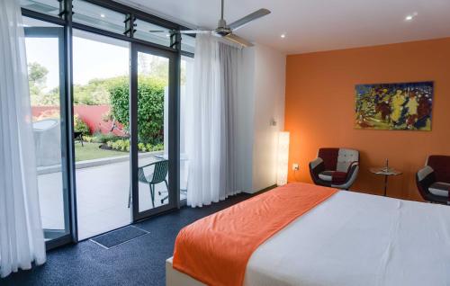 a bedroom with a bed and a large window at Serene-estate Boutique Guesthouse in St Lucia