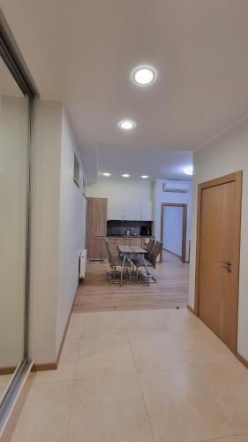 an empty room with a table and a dining room at Black Pearl Apartments in Jūrmala