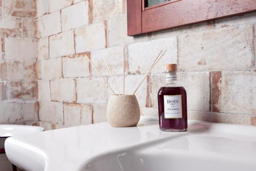 a bottle of wine sitting on top of a sink at Tenuta il Poggetto in Radda in Chianti