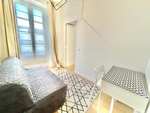 a room with a couch and a table and a window at Jaurès Home by Welcome to Cannes in Cannes