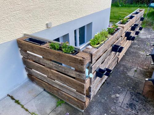 a wooden planter on the side of a building with plants at Natalies Hideaway in Thun