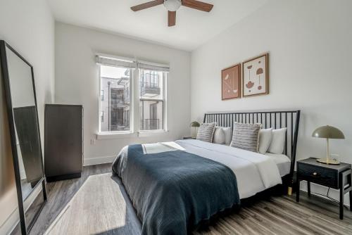 a bedroom with a bed and a flat screen tv at Highlands 1br w pool wd gym vibrant area ATX-201 in Austin