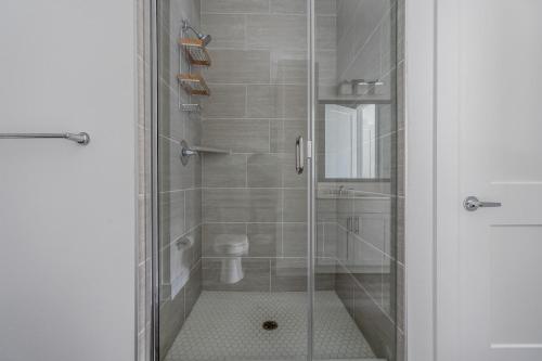 a bathroom with a glass shower with a toilet at Highlands 1br w pool wd gym vibrant area ATX-201 in Austin