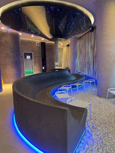 a room with a stage with chairs and a ceiling at WAVEVIEW PREMIUM 10th Floor Baltic View in Międzyzdroje