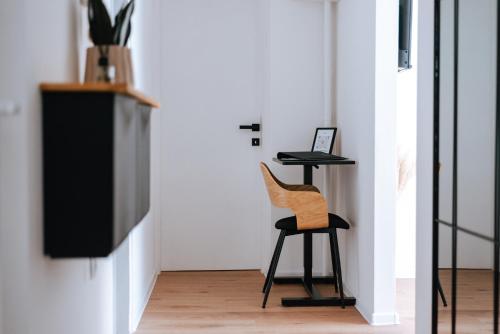 a chair and a table in a room at Apartman Vista in Daruvar