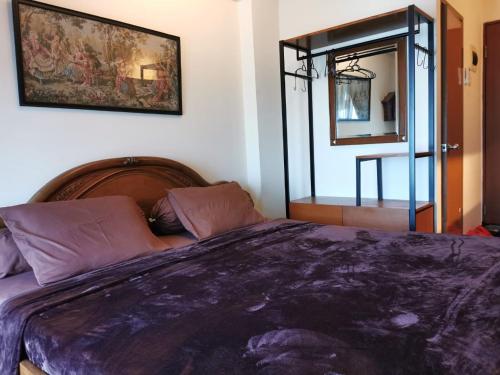 a bedroom with a large bed and a mirror at Pleasant05tifolia in Jakarta