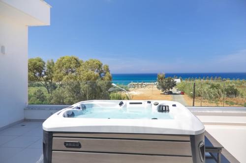 a bath tub with a view of the ocean at Seaview Luxury Villa Jacuzzi & Pool! 2 Min Beach in Protaras