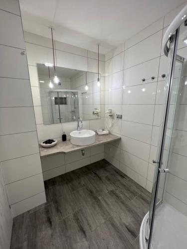 a white bathroom with a sink and a mirror at Apartment,holiday home, Kutná Hora in Kutná Hora