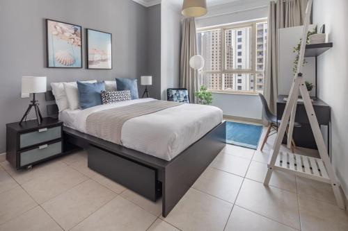 a bedroom with a bed and a ladder in it at Frank Porter - Marina Quays in Dubai