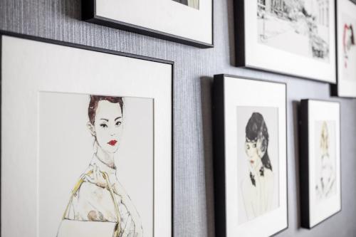a bunch of pictures hanging on a wall at Riahouse KINTEX 1min 2room in Goyang