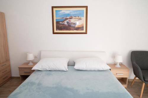 a bedroom with a bed and a picture on the wall at Apartments Matic Vodice in Vodice