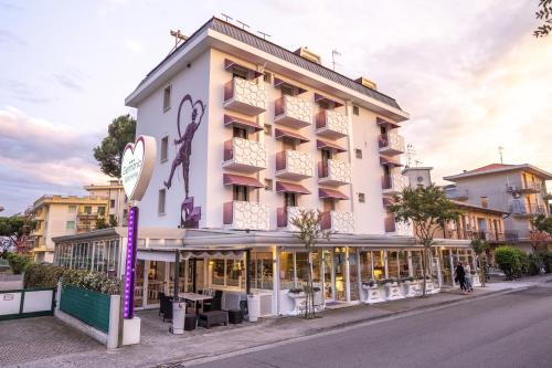 a large white building with a sign in front of it at Hotel Germania in Lido di Jesolo