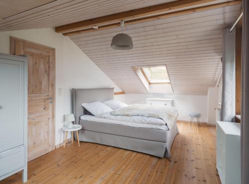 a bedroom with a large bed in a attic at Glueckszeitraum in Glücksburg