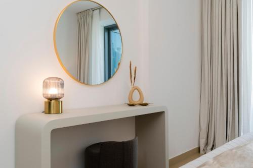 a mirror above a fireplace in a living room at Prestige Living 2BR with Full Burj Khalifa and Fountain View by Auberge in Dubai