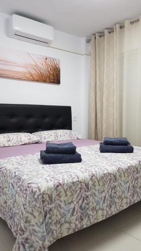 two blue pillows on a bed in a room at Royal II in Salou