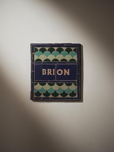a sign for a broon on a wall at IZZA Marrakech in Marrakech