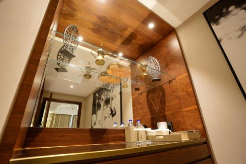 a bathroom with a mirror and a sink at Mirfa Hotel in Al Marfaʼ