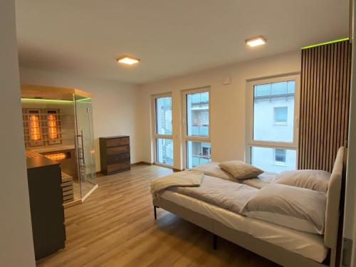 a large bedroom with a bed and a fireplace at Hideaway Lounge Sure in Echternacherbrück