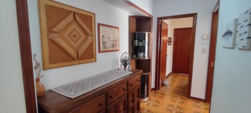 a room with a wooden dresser and a mirror at La bouganville Apartments in Cala Gonone