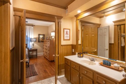 a bathroom with a sink and a mirror at Southern Elegance in Heart of Memphis in Memphis