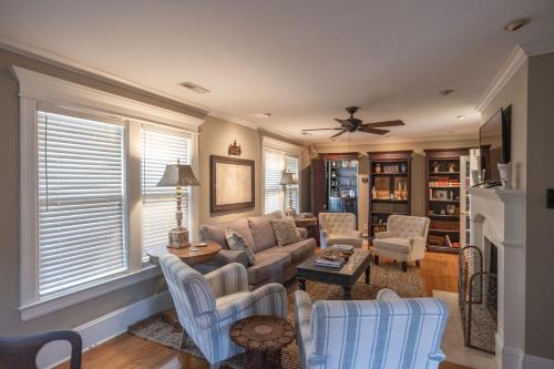 a living room with a couch and chairs and a fireplace at Southern Elegance in Heart of Memphis in Memphis