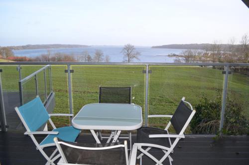 a table and chairs on a balcony with a view at Naturperlen in Rødekro