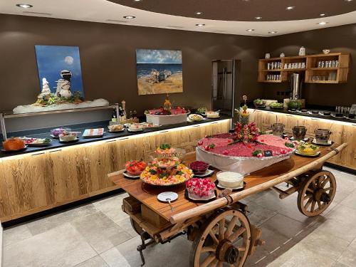 a buffet with many different foods on a table at Hotel Spöl Restaurant in Zernez