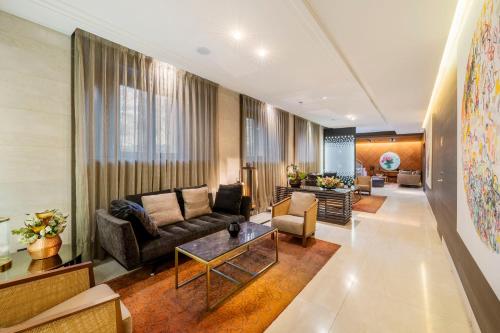 a living room with a couch and a table at Áurea Washington Irving by Eurostars Hotel Company in Granada