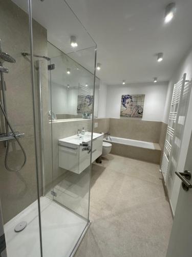 a bathroom with a shower and a sink and a toilet at Villa Les Palmiers St. Maxime in Sainte-Maxime