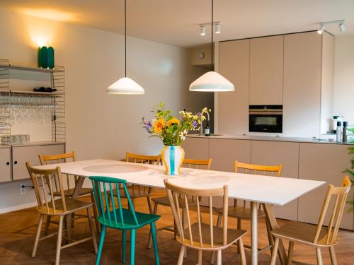 uma cozinha e sala de jantar com uma mesa branca e cadeiras em Living Lodges - Durbuy em Durbuy