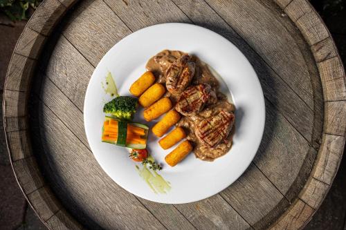 a plate of food with meat and carrots and broccoli at 5 Sunca in Kašina