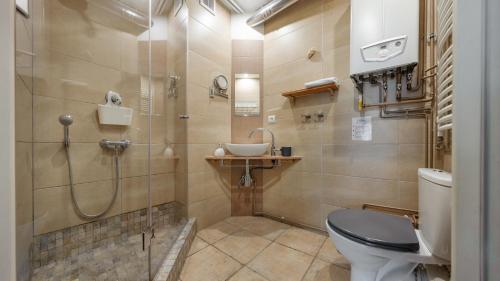 a bathroom with a shower and a toilet and a sink at Apartamenty Sun & Snow Obrońców Westerplatte 8 in Sopot