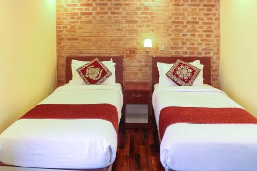 Postel nebo postele na pokoji v ubytování Budhanilkantha Sacred Trails Kathmandu Homestay