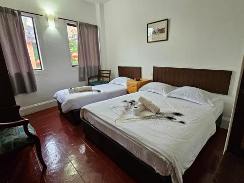 1 dormitorio con 2 camas y ventana en Little India Heritage Villa en George Town