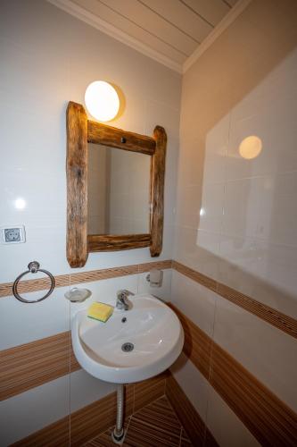 a bathroom with a sink and a mirror at Недкова къща in Koprivshtitsa