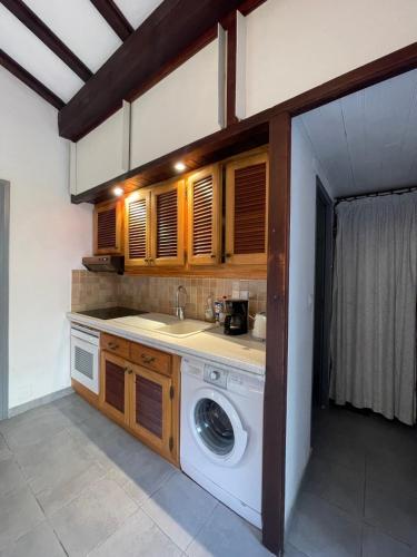 une cuisine avec une machine à laver dans une pièce dans l'établissement Villa Alando, Santa Giulia, à Porto-Vecchio