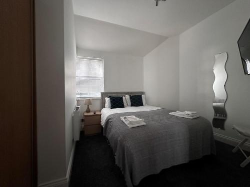 ein weißes Schlafzimmer mit einem Bett und einem Fenster in der Unterkunft Apt 4, Soho Apartments 2nd floor by Indigo Flats in London
