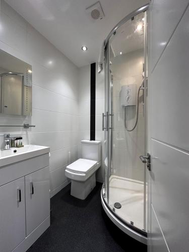a bathroom with a shower and a toilet and a sink at Apt 4, Soho Apartments 2nd floor by Indigo Flats in London